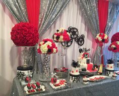 a table topped with lots of red and white flowers