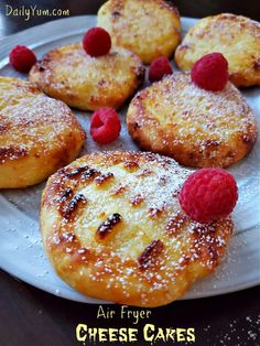 some food that is on a plate and has raspberries on top of it