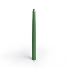 a tall green candle sitting on top of a white surface