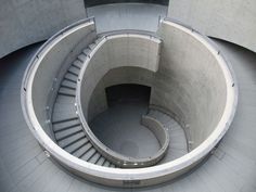 an aerial view of the inside of a spiral staircase in a concrete structure with steps leading up to it