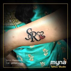 a woman's arm with the word sr2 on it and hearts in black ink