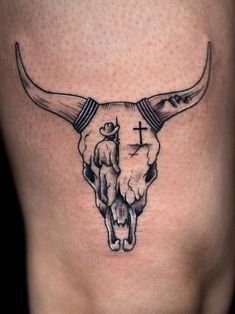 a bull skull with a cross on it's side