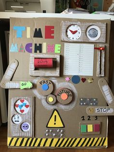 a cardboard box with magnets and paper on the top that says time machine in front of it