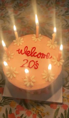 a birthday cake with lit candles and the words welcome 205 on it's frosting