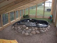 an outdoor hot tub in the middle of a garden with rocks and gravel around it