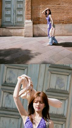 a woman standing in front of a building with her hands on her head and the other side of her face