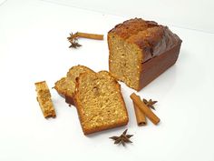 two slices of bread and cinnamon sticks on a white surface with star anise sprinkles