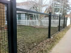 a black fence is in front of a house