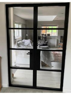 an open glass door leading to a bedroom