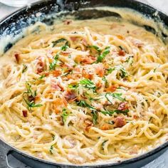 a skillet filled with pasta and bacon