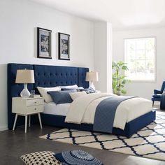 a bedroom with white walls and blue bedding