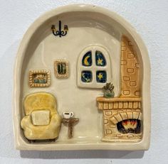 a ceramic figurine of a living room with furniture