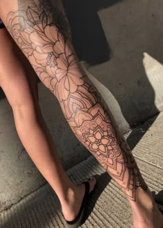 a woman's legs with tattoos on them