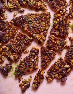 several pieces of chocolate and nuts on a cutting board