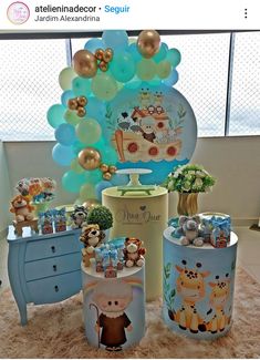 there are many items on the table for this baby's first birthday party, including balloons and decorations