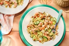 two plates of food on a table with utensils