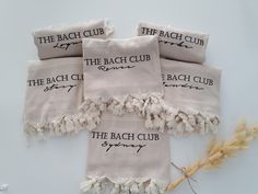 four towels with the beach club written on them