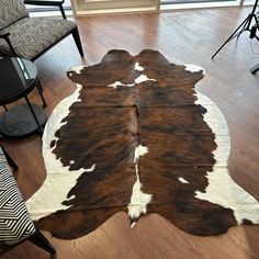 a brown and white cowhide rug in a living room