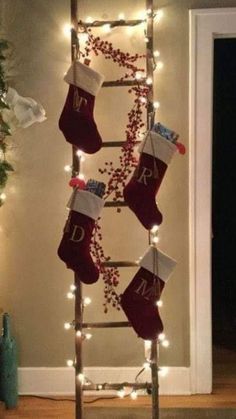 a ladder decorated with stockings and christmas lights