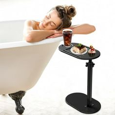 there is a woman laying down in the bathtub with her head resting on a tray