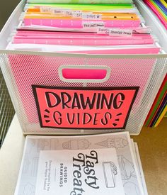 a pink file box filled with lots of books and papers on top of a table