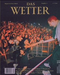 a magazine cover with a photo of a man in front of a crowd