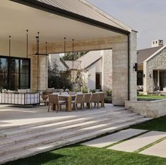 an outdoor dining area with steps leading to the patio