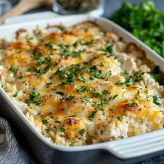 a casserole dish with chicken, cheese and parsley