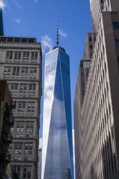 the one world trade center in new york city, with skyscrapers on either side