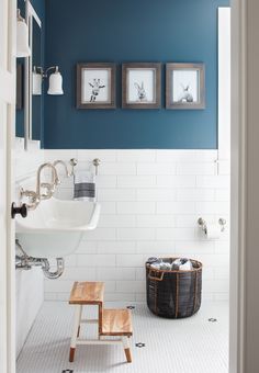 a bathroom with blue walls and white tile on the floor is featured in this article