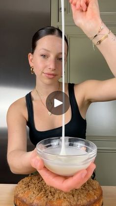 a woman is pouring milk into a bowl