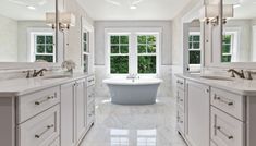 a large bathroom with two sinks and a bathtub in the middle of the room