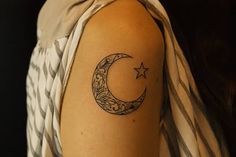 a woman with a crescent and star tattoo on her arm