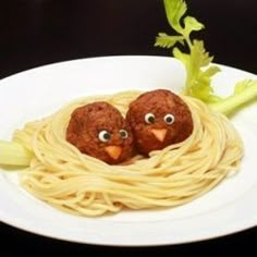 two birds made out of spaghetti on a plate