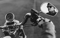 black and white photograph of a man in sunglasses on a motorcycle