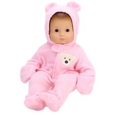 a baby doll is wearing a pink bear outfit and sitting on the floor with its legs crossed