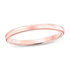 a plain wedding band in rose gold, with the edge slightly bent to show it's thinness