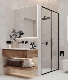 a bathroom with a toilet, sink and shower stall