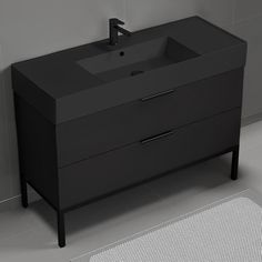 a bathroom sink sitting on top of a black cabinet