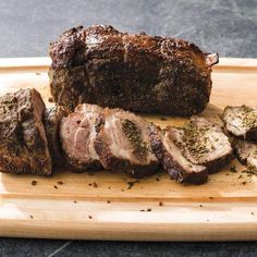 sliced up meat on a cutting board with seasoning