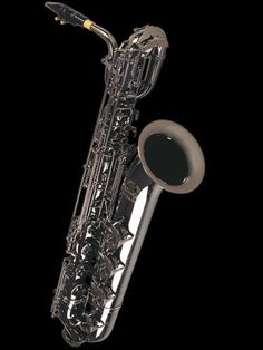 a close up of a saxophone on a black background