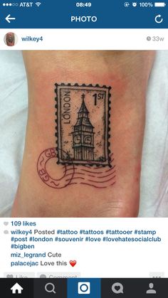 a small tattoo on the foot of a person with a postage stamp in front of them