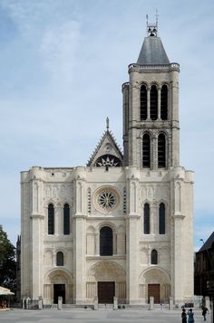 a large white church with a clock on the front