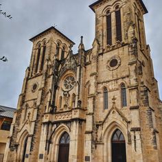 an old church with two tall towers and windows