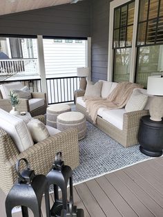 the front porch is decorated with wicker furniture