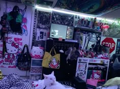 a room filled with lots of clutter and bags on top of the floor in front of a hello kitty wall