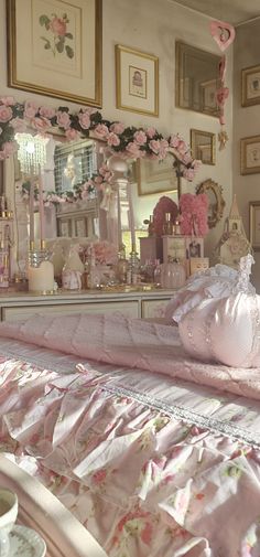 there is a bed with pink flowers on it and a mirror in the corner behind it