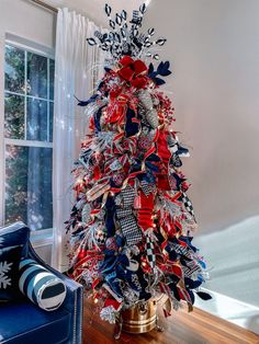 a christmas tree decorated with red, white and blue ribbons