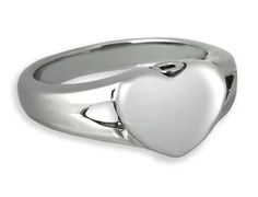 a silver ring with a heart on the front and center, set against a white background