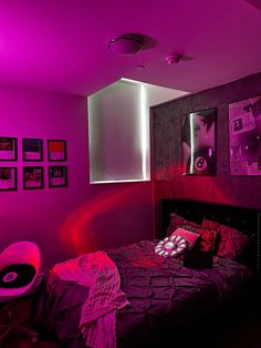 a bed room with a neatly made bed and purple lighting on the wall above it